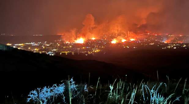 Buildings burn as a wind-driven grass fire destroys hundreds of homes, displaces thousands, as seen from Denver, Colorado, U.S. December 30, 2021