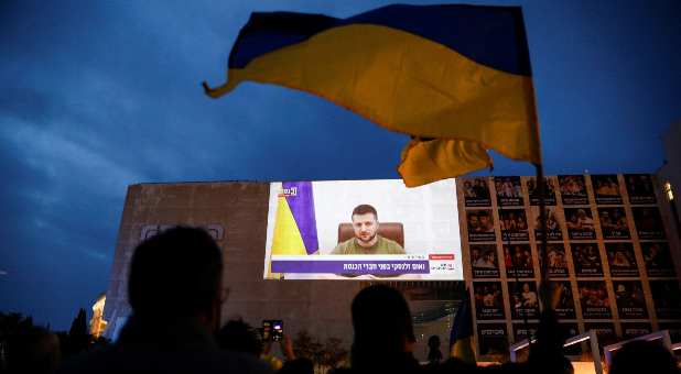 Demonstrators gather in support of Ukraine following Russia's invasion, and watch Zelenskiy's speech as it is broadcasted to the Knesset, Israel's parliament, and projected at Habima Square in Tel Aviv, Israel, March 20, 2022.