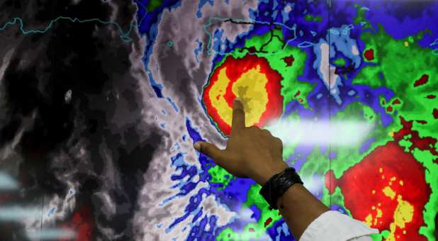 A member of the Emergency Operations Committee (COE) monitors the trajectory of Hurricane Fiona in Santo Domingo, Dominican Republic, September 18, 2022.