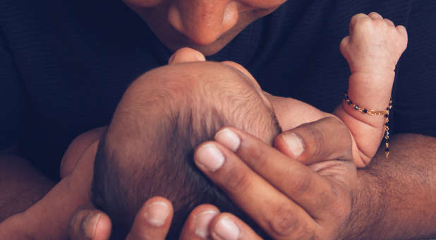 infant in parent's arms