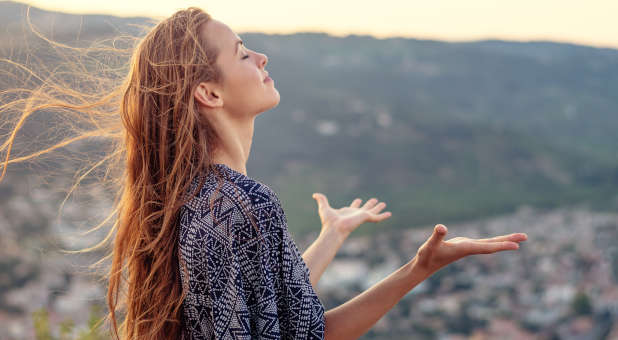 A woman praising God.