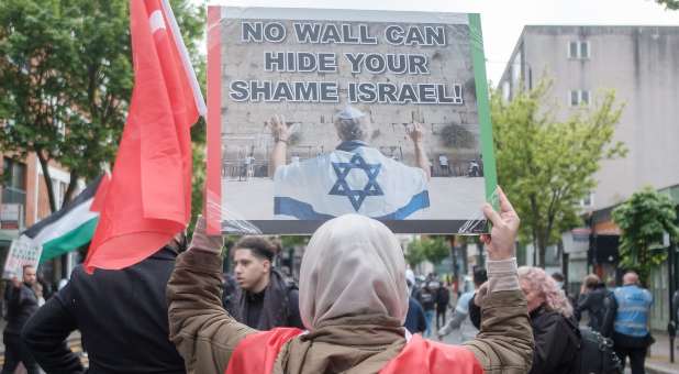 Signs and Palestinian flags at an anti-Israel protest