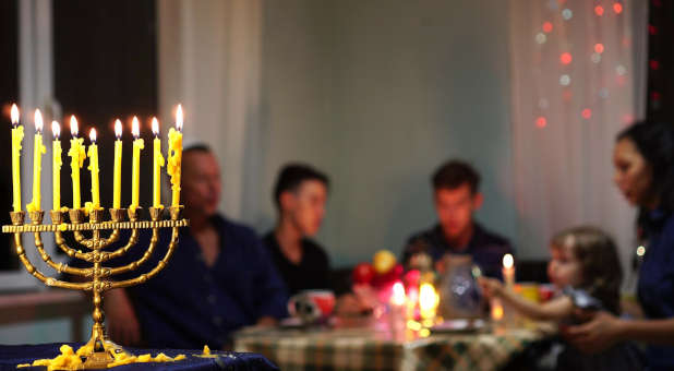 Jewish family celebrating Hanukkah.