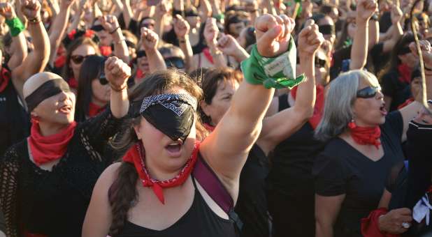 Women protesting with fists in air.