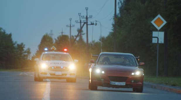 Sports car fleeing police in a high speed chase.