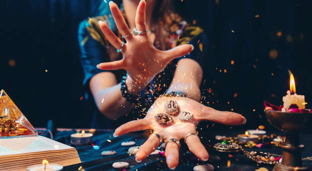 An astrologer practicing divination.